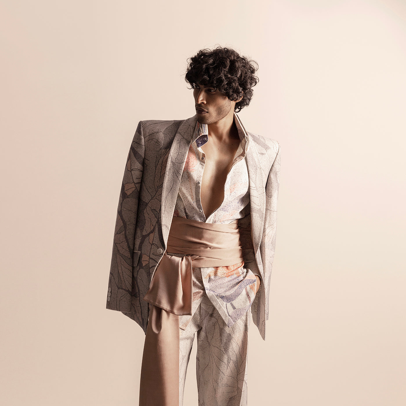 Nadru printed suit with draped blazer and soft pink sash – modern artistic menswear, men's fashion sash, artistic print, bold menswear style