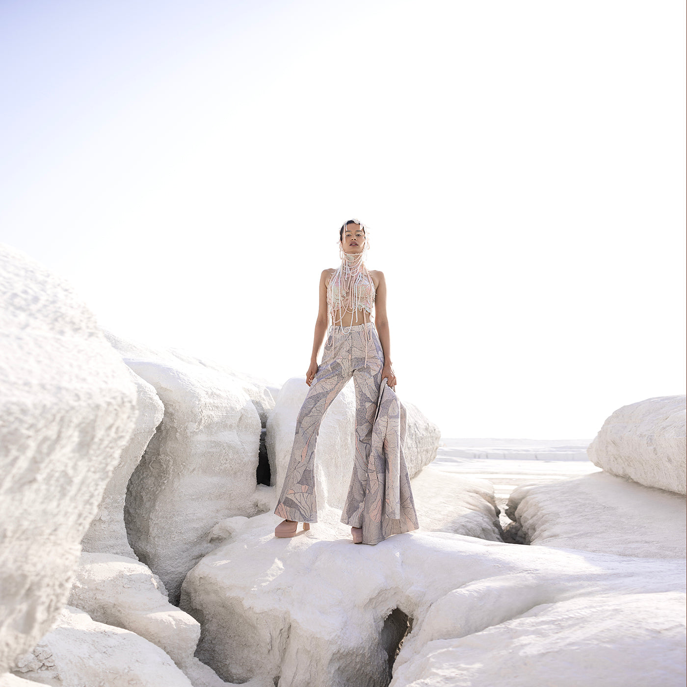 Full view of Nadru printed pant suit with crop top and elaborate headwear – printed pants, crop top, elaborate headwear, bold fashion, designer womenswear, statement outfit