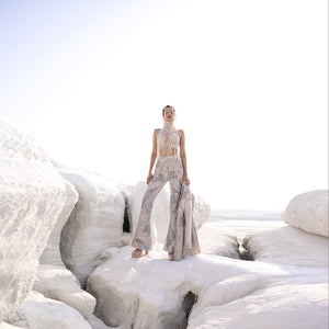 Full view of Nadru printed pant suit with crop top and elaborate headwear – printed pants, crop top, elaborate headwear, bold fashion, designer womenswear, statement outfit