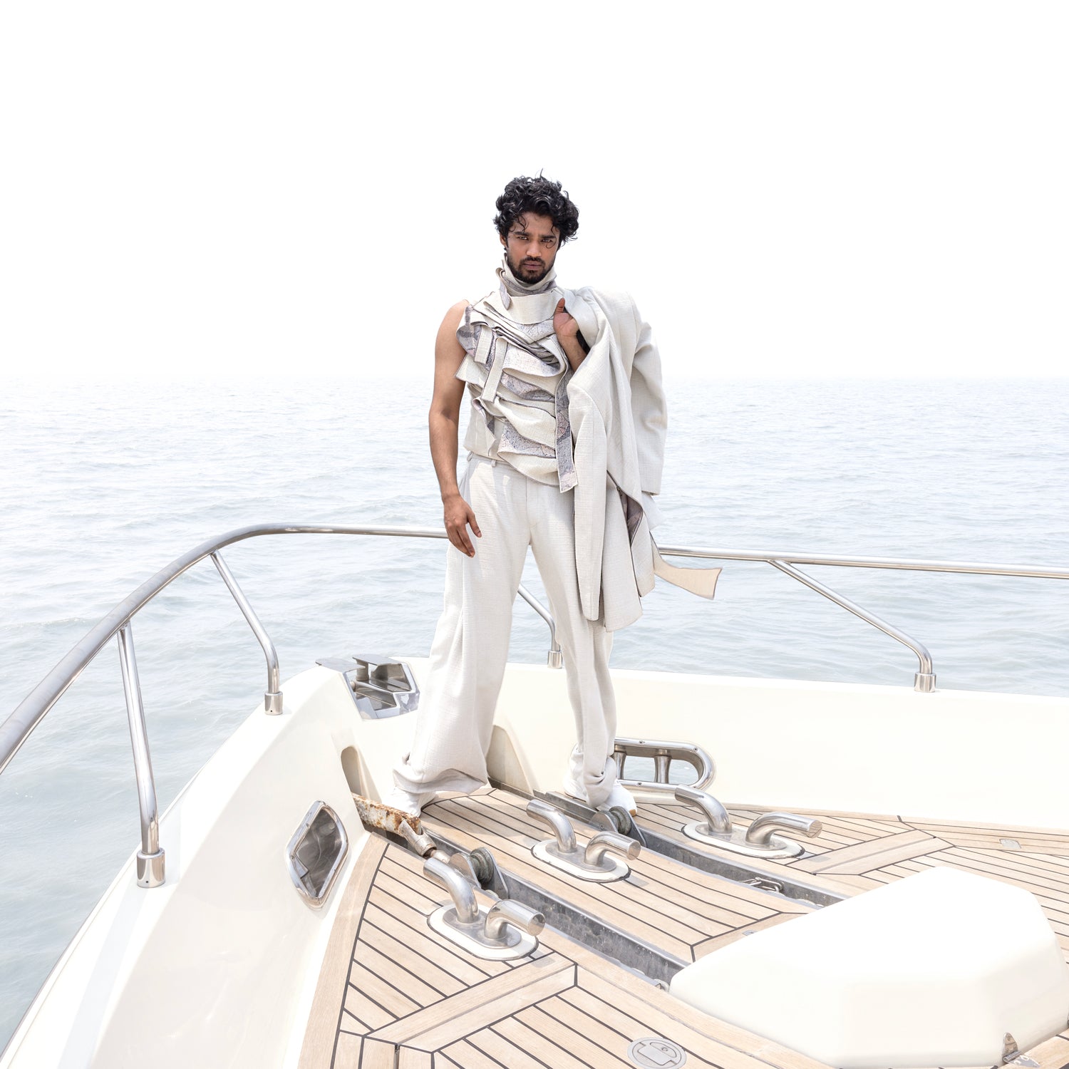 Men's ivory bandhgala styled over layered t-shirt and wide-hem pleated trousers – contemporary Indian formalwear
