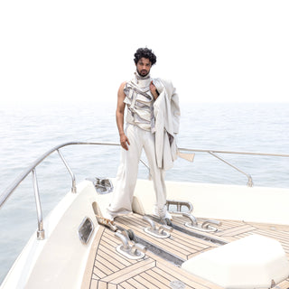 Men's ivory bandhgala styled over layered t-shirt and wide-hem pleated trousers – contemporary Indian formalwear