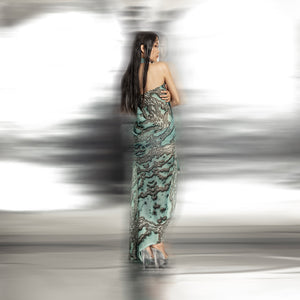 back view of Women's reef halter neck gown back view with elegant draping and coral-textured fabric – fluid silhouette for luxury eveningwear