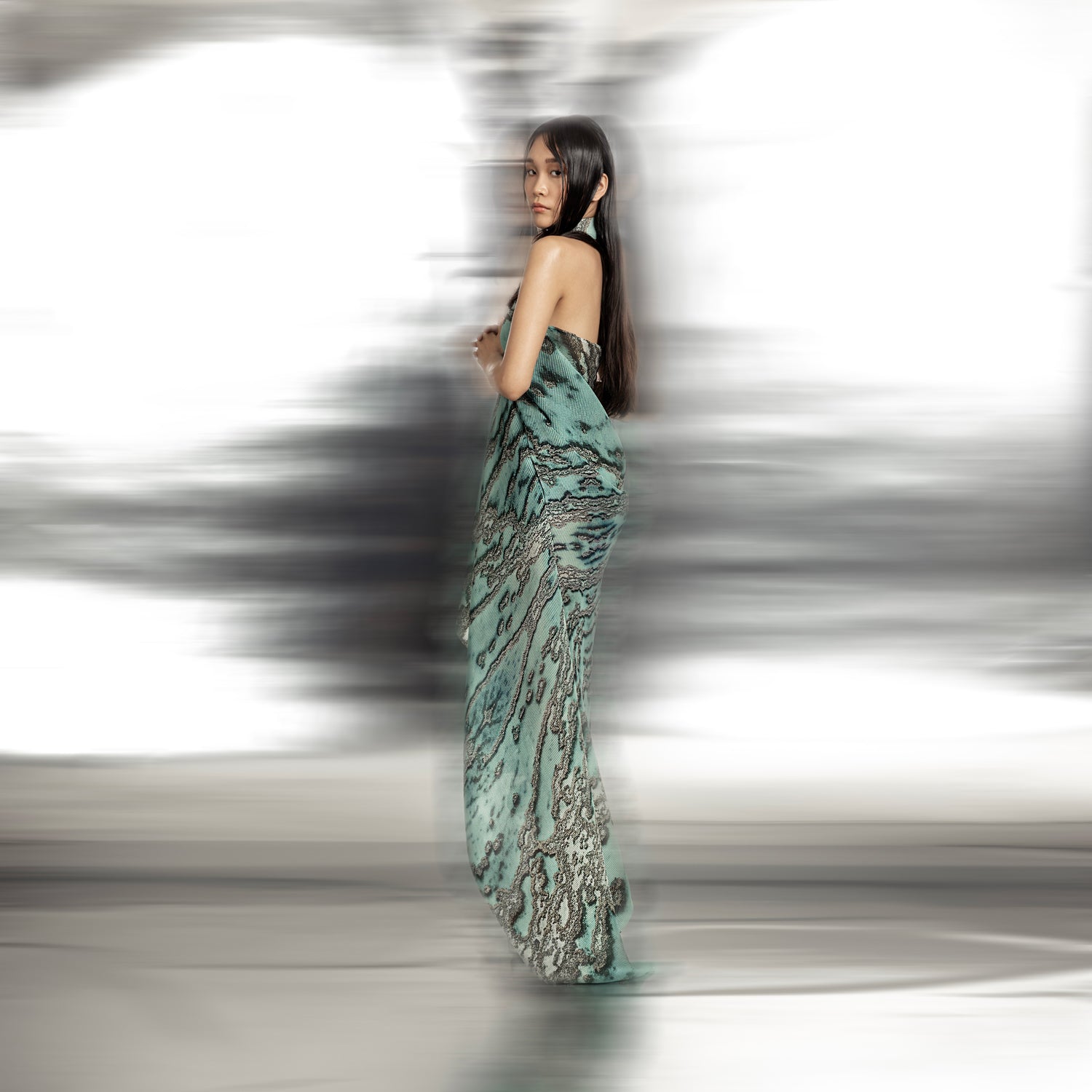 side view of Women's reef printed halter gown back view with asymmetric drape and sculpted silhouette – fluid luxury couture inspired by ocean forms