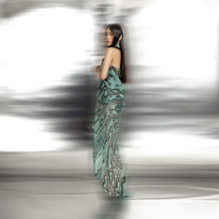 side view of Women's reef printed halter gown back view with asymmetric drape and sculpted silhouette – fluid luxury couture inspired by ocean forms