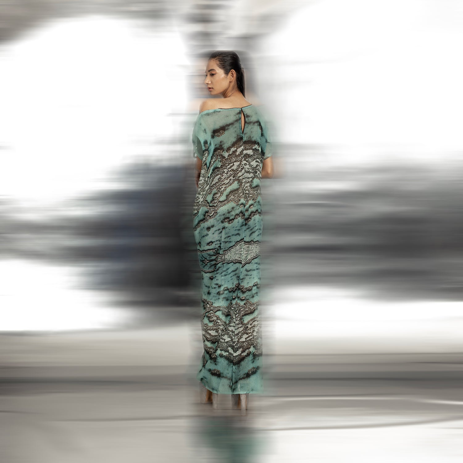 back view of Women's ocean reef print pleated gown with keyhole back and soft drop shoulder – fluid asymmetrical evening dress