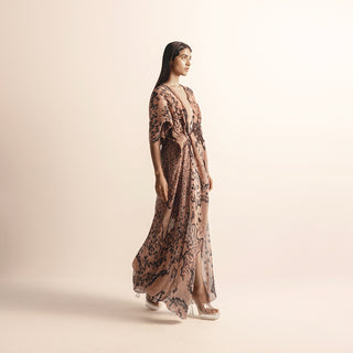 profile shot of Women's blush coral reef printed chiffon gown with front slit and heat textured draping – fluid couture silhouette