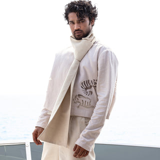 Men's ivory summer co-ord featuring cropped cutwork jacket, pleated relaxed trousers, and soft drape scarf – effortless resort styling