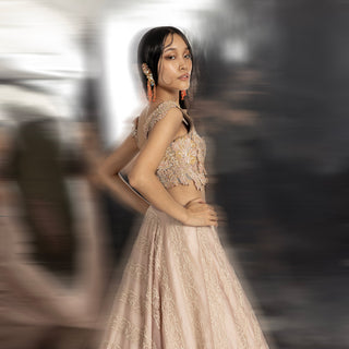Side view of women's embellished blouse and silk organza lehenga with reef embroidery – contemporary bridal couture