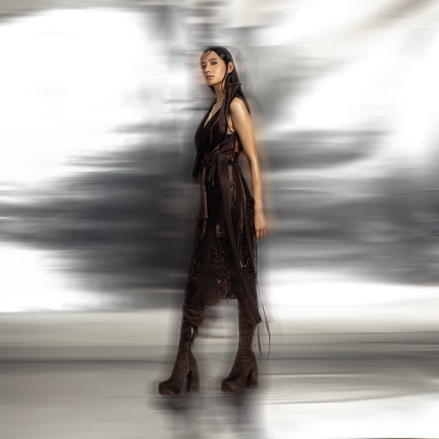 full side view of Women's dark brown wrap top with side sash and textured skirt – edgy structured co-ord for formal styling