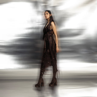 full side view of Women's dark brown wrap top with side sash and textured skirt – edgy structured co-ord for formal styling
