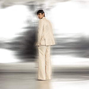 full back view of Men's ivory textured blazer with shawl collar and side slit detail – coordinated red carpet ensemble from back view