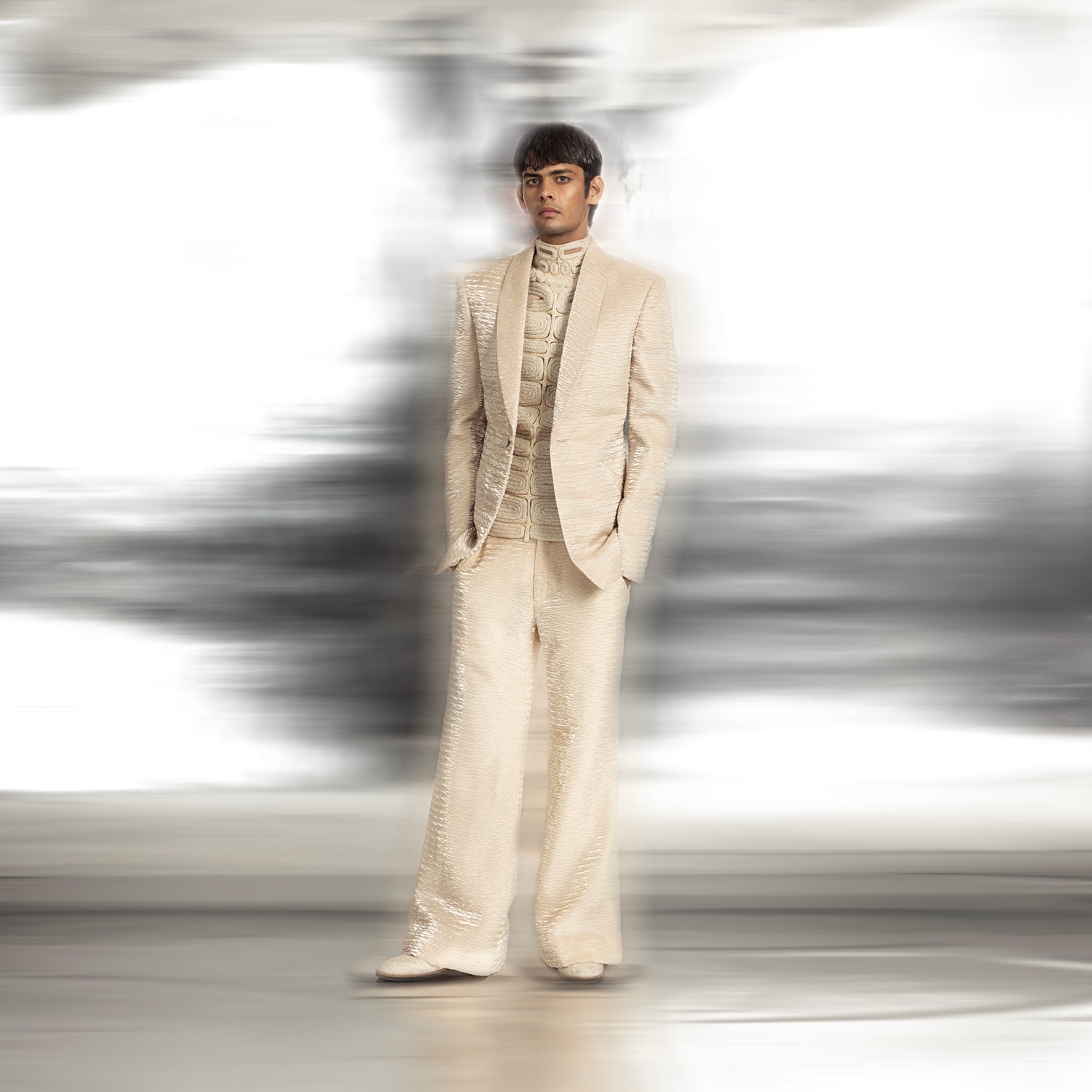 full length of Men's ivory textured coord set with shawl collar blazer and sculpted yarn couching turtleneck – red carpet ensemble