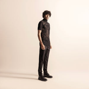 Men's black short-sleeve top with intricate yarn embroidery – avant-garde festivewear with structured pants