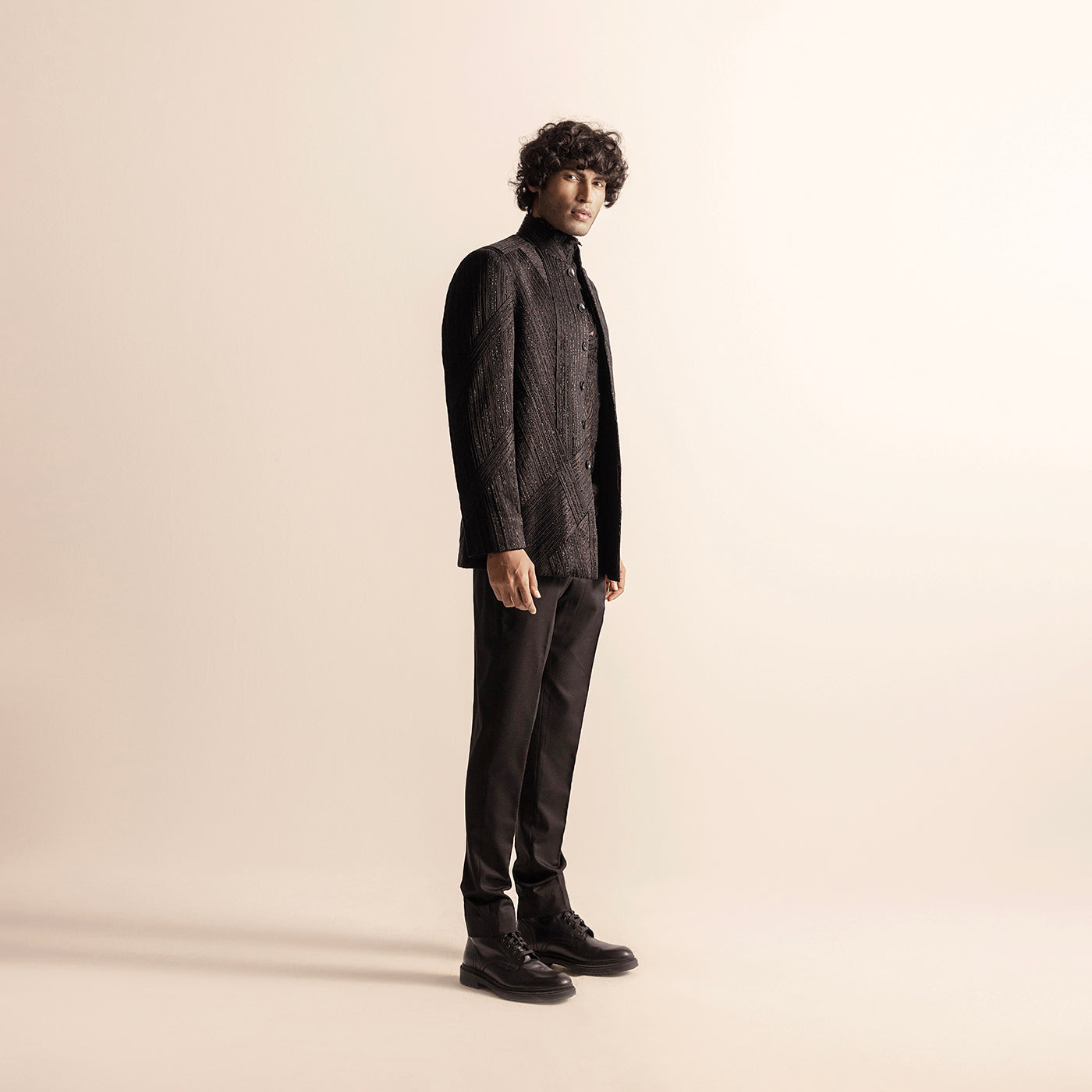 full side view of Men's black Bandhgala with geometric yarn detailing and slim trousers – structured designer festive set