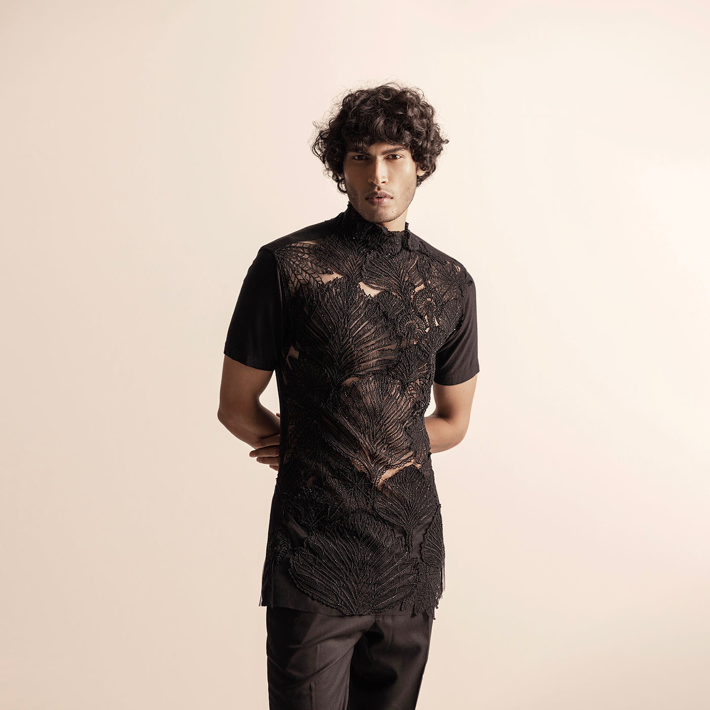 Men's black short-sleeve top with sheer base and raised leaf embroidery – couture festivewear with modern edge