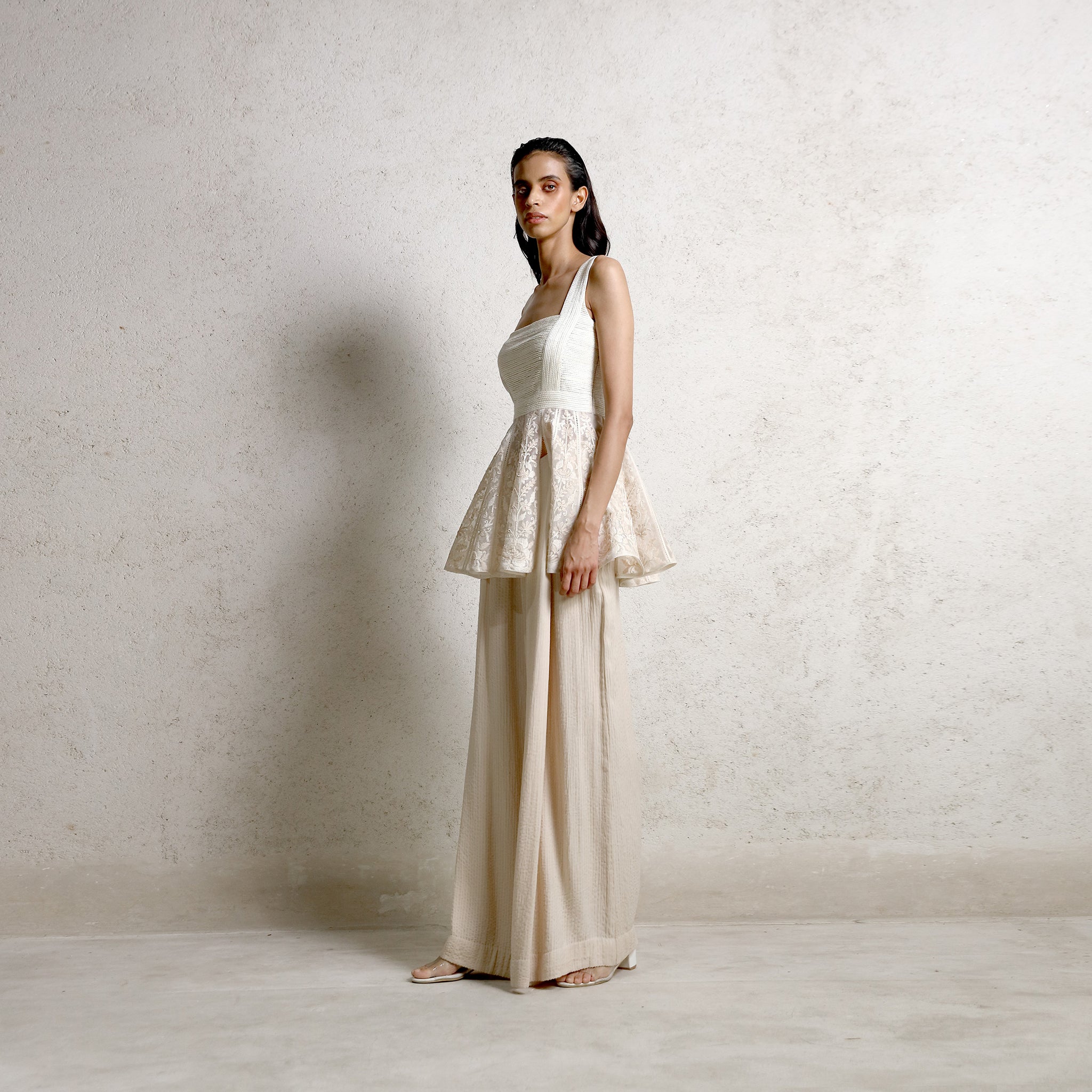 Fine shadow works tonal embroidered peplum top with fine pearl highlighting teamed up textured chiffon high waisted. The look has a very elegant classic feel. the play of textured lines adds in the modern edgy touch. the look is a perfect pic for a high tea or a lunch where you want to speak style and elegance without saying much. #Abhishekstudio #abhisheksharma  #fashiondesignerabhisheksharma #designerware #ambawattaone