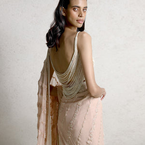 Fine chikankari saree having diagonal floral lines forming the palla, embellished with fine pearl and crystals. The blouse has an intense play of draped pearl strings. The look is perfect for traditional and modern-day styling. #Abhishekstudio #abhisheksharma  #fashiondesignerabhisheksharma #designerware #ambawattaone #lakmefashionweek  #weddingware #bridal #modrenbride #chikankari