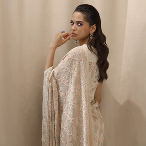 Fine chikankari saree with intense zari jaali detailing and intense pearl embroidery, teamed up with net applique embellished blouse. The saree has an intense display of fine chikankari craftsmanship. The palla has beautiful zari jaali work all densely done by the craftsmen from Lucknow showing the finest of skills. #Abhishekstudio #abhisheksharma  #fashiondesignerabhisheksharma #designerware #ambawattaone #lakmefashionweek  #weddingware #bridal #modrenbride #chikankari
