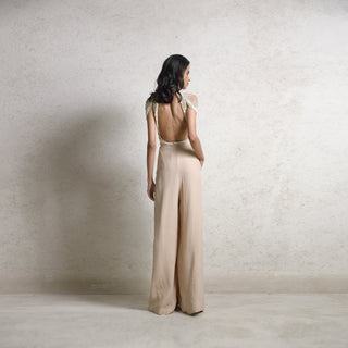 Draped pearl string high neck collar backless Top teamed up with textured chiffon high waisted pants. There is the intense use of various sizes of pearls and draped hand details that create a form with individual pearl strings giving it its structure. the look a statement piece and a perfect when you wish to make a fashion statement. #Abhishekstudio #abhisheksharma  #fashiondesignerabhisheksharma #designerware #ambawattaone #lakmefashionweek  #weddingware #bridal #modrenbride 