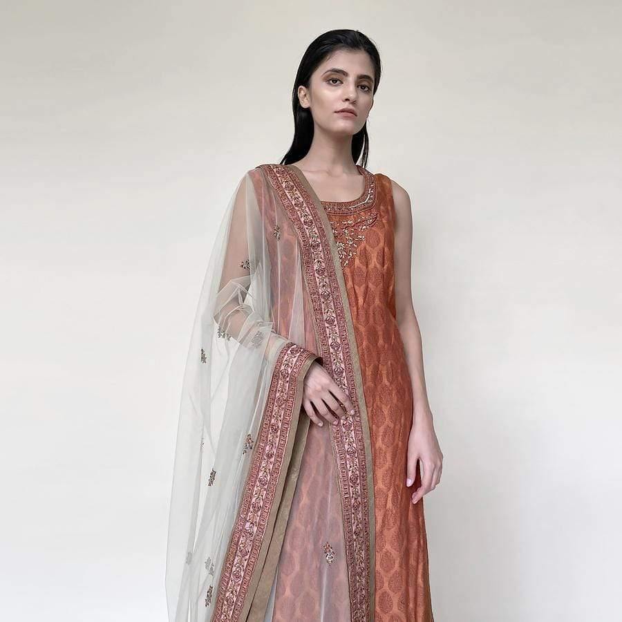Tanchoi Kurta with fine self texture sleeveless kurta with embellished dupatta and tissue chandheri sharara. There is fine Resham, sequin and katdan embroidery. the look has elegant vibes. it works perfectly for an evening simple get together with family. 