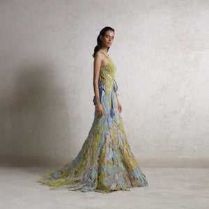 A long halter dress embellished fishtail cut gown with drip satin, fine Resham, and sequin detailing with intense bugle bead texturing. The gown has a very unique and couture feel perfect for a destination wedding. The play of unconventional motifs and colors makes it stand out. #Abhishekstudio #abhisheksharma  #fashiondesignerabhisheksharma #designerware #ambawattaone #lakmefashionweek #wommen’sware 