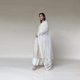 Silk organza embellished layered straight kurta with fine Resham, velvet applique and bead embroidery. The kurta has a fine voile crinkled under layer as lining giving it a layered look. there is a fine play of flower lines and geometric lines that gives the style a unique feel. The look is a perfect pick for someone who has an eye for detail and elegance. Abhishekstudio, Abhishek Sharma.