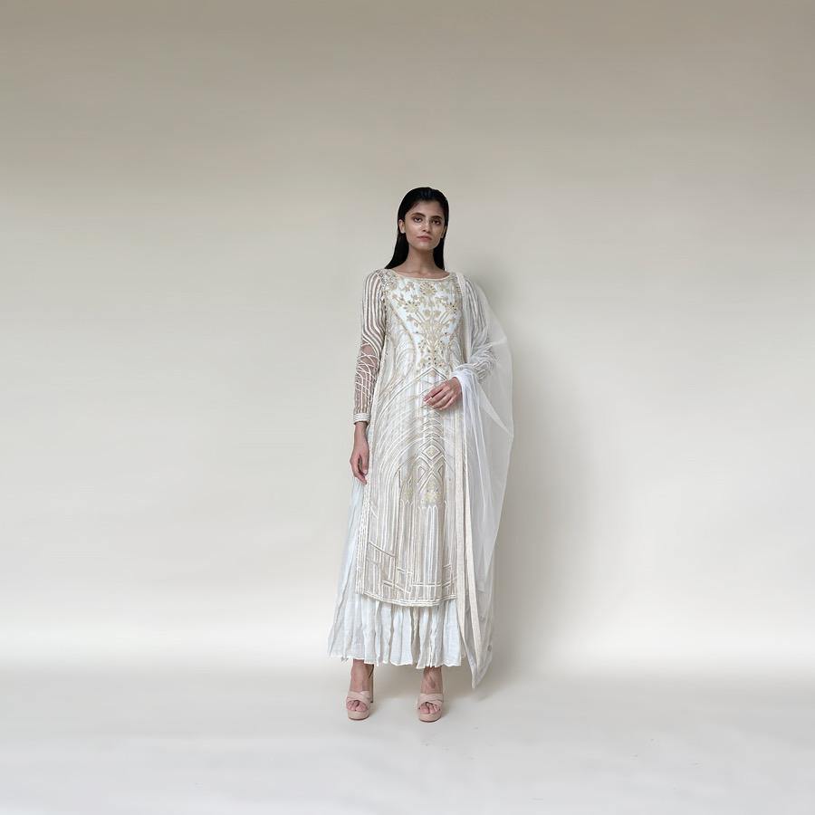 Silk organza embellished layered straight kurta with fine Resham, velvet applique and bead embroidery. The kurta has a fine voile crinkled under layer as lining giving it a layered look. there is a fine play of flower lines and geometric lines that gives the style a unique feel. The look is a perfect pick for someone who has an eye for detail and elegance. Abhishekstudio, Abhishek Sharma.