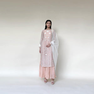 Organza silk kurta with fine Gresham and velvet applique embroidery embellished with pearl and katdana. There is separate crinkled voile inner that gives the style a layered look. Elegance and delicate details are the main focus of the look. Abhishek Sharma, abhishekstudio