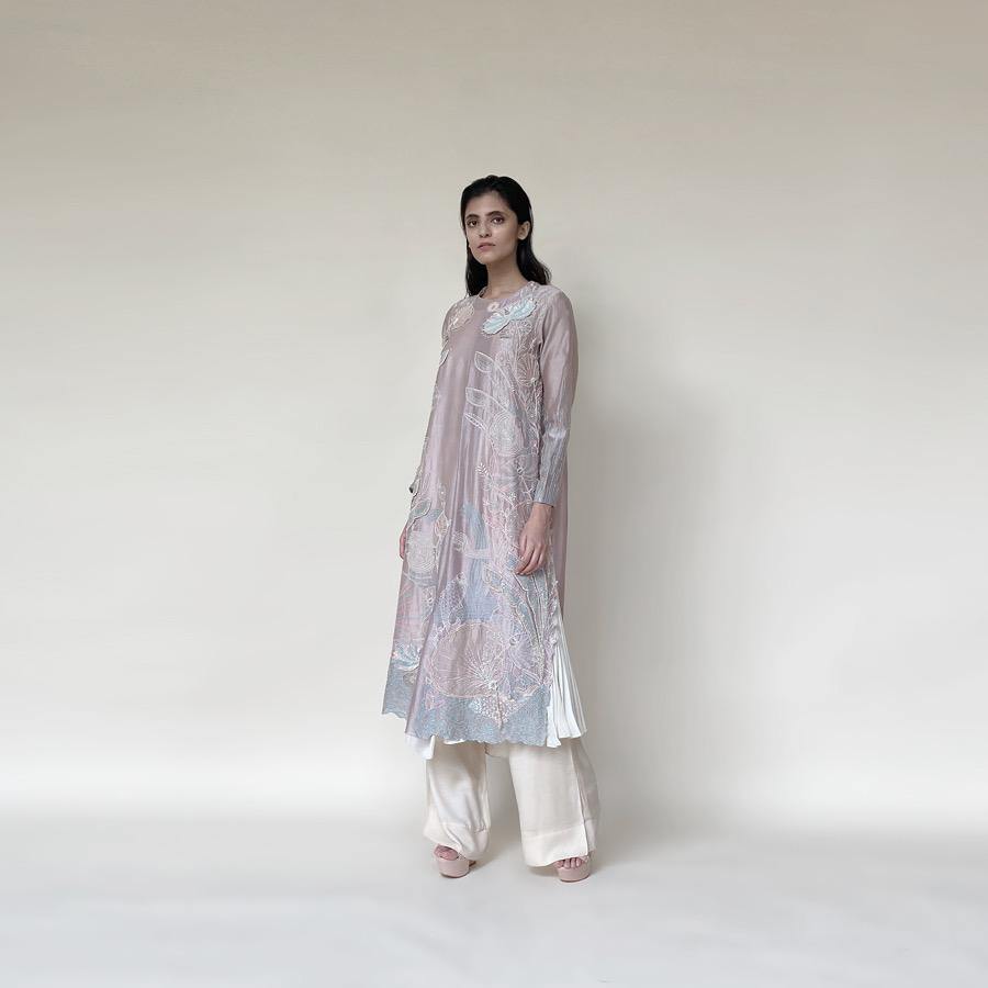 Embellished Kurt with front plate, wide pants and dupatta. The kurta has fine resham and pearl 3D embroidery that adds the elegance to the look. It's a look that works for day and night both.