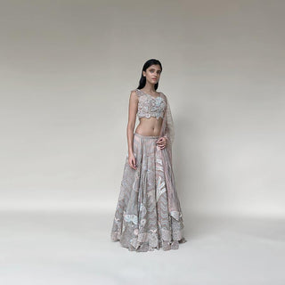 Organza silk lengha with a fine play of geometric and floral motifs with 3D embroidery and bugle bead detailing on the blouse. There is a fine play of Resham, sequin, pearl and katdana detailing. The look has playful young vibes that is perfect for someone who loves new and different vision about design. Abhishek Sharma, Abhishekstudio.