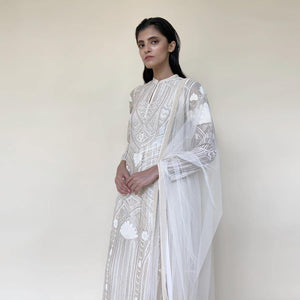 Organza silk kurta with fine Gresham and velvet applique embroidery embellished with pearl and katdana. There is a separate crinkled voile inner that gives the style a layered look. Elegance and delicate details are the main focus of the look. Abhishek Sharma, abhishekstudio