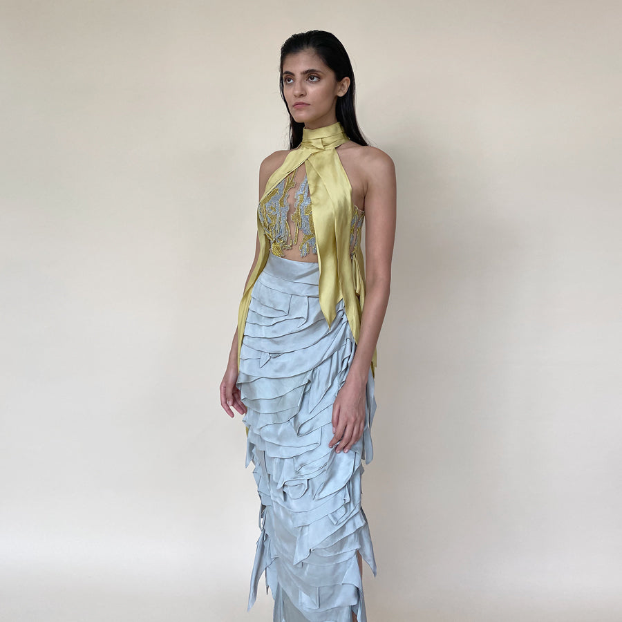 The look has turtle neck draped embroidery detailing along with satin drip texturing. The skirt has multiple layer of satin with asymmetrical patterns. The look is perfect for red carpet and event where you are the head turner. Lead the evening with this power packed strong look. Abhishek Sharma, abhishekstudio 