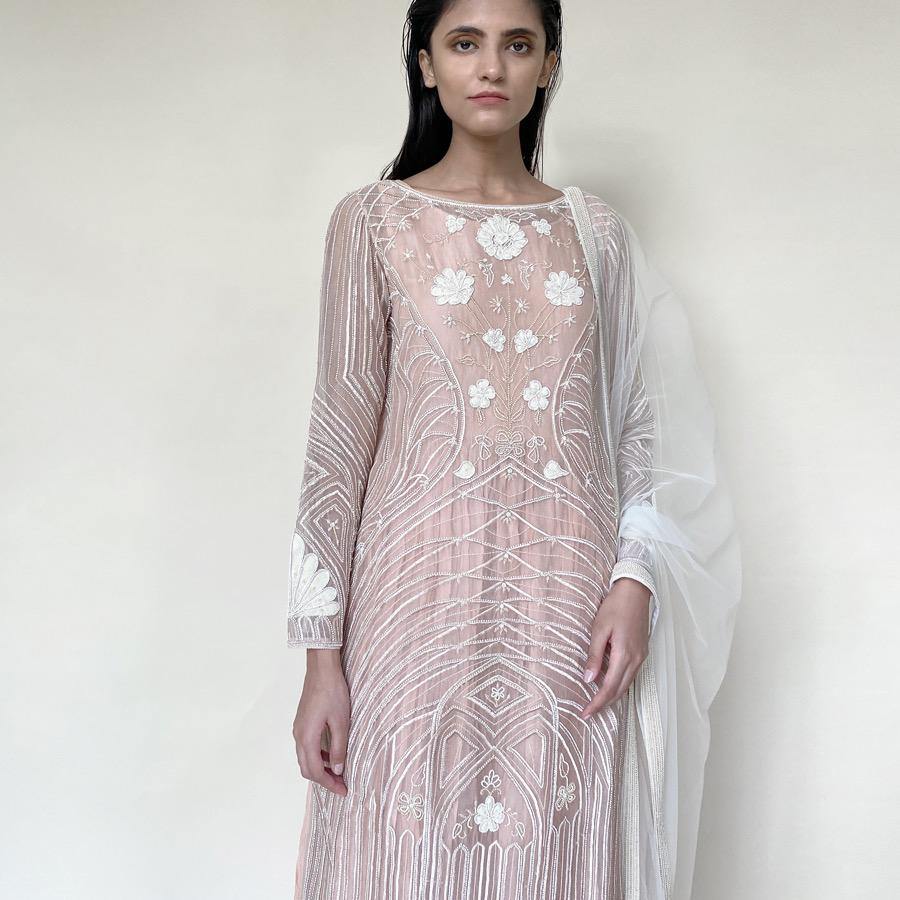 Organza silk kurta with fine Gresham and velvet applique embroidery embellished with pearl and katdana. There is separate crinkled voile inner that gives the style a layered look. Elegance and delicate details are the main focus of the look. Abhishek Sharma, abhishekstudio