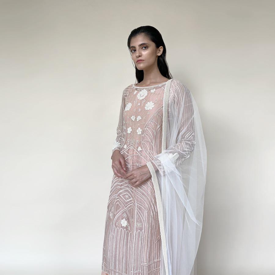 Organza silk kurta with fine Gresham and velvet applique embroidery embellished with pearl and katdana. There is separate crinkled voile inner that gives the style a layered look. Elegance and delicate details are the main focus of the look. Abhishek Sharma, abhishekstudio