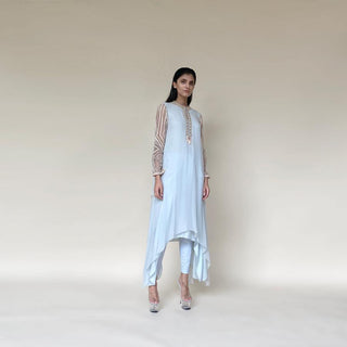 Draped asymmetrical chiffon kurta with embellished sleeves and neckline. The style is very elegant and fluid. The style is comfortable and elegant. The look is a perfect pick for someone who loves the elegance and yet like to be different. The look works perfectly for a day as well as a relaxed evening affair.  