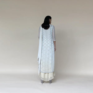 Chiffon Kalidas kurta with fine Resham shadow work and sequin embroidery. The kurta set has layered look and comes with a draped shaped stole, fitted pants and separate flared lining. The look is perfect for a refreshing and relaxed day. The look is perfect when you want to carry the grace and elegance with understated style. 