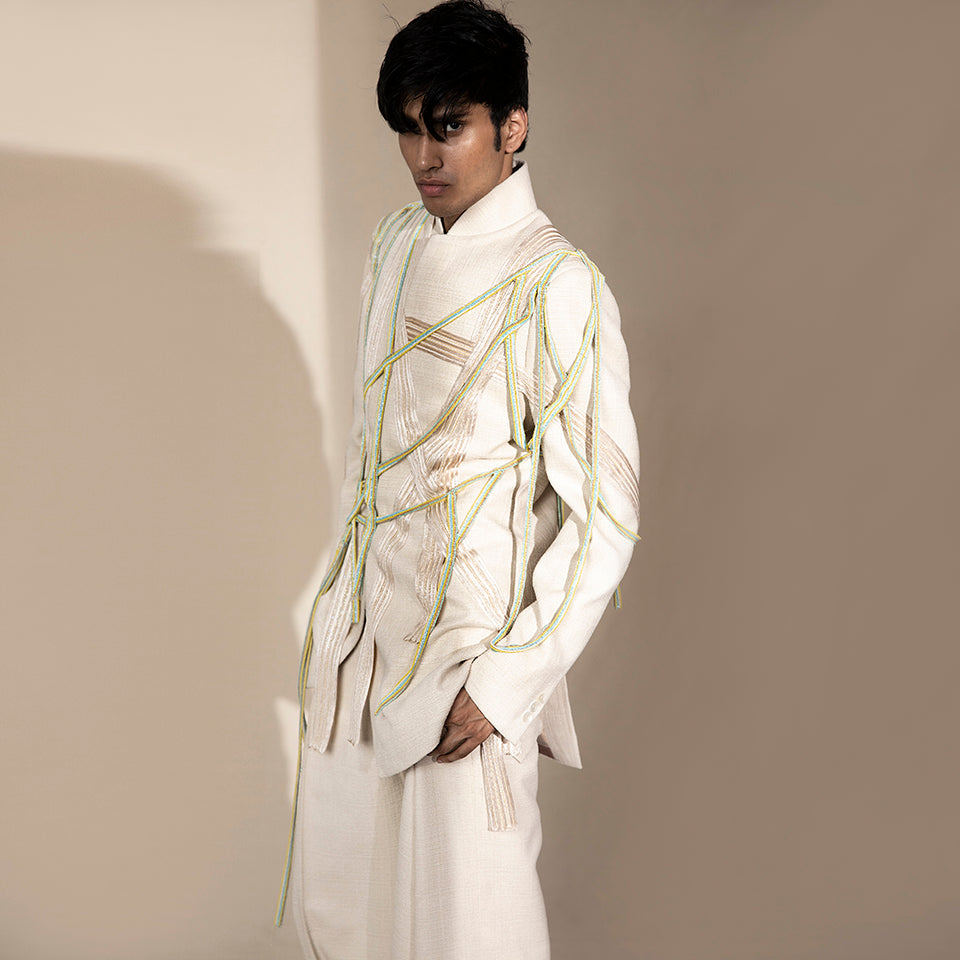 handloom bandgala jacket with criss-cross embellishment and mesh of neon beaded strings. the jacket is teamed up pleated wide pants. the look is perfect for someone who has style and believes in making a mark. the look is definitely a head turner.  #abhisheksharma #abhishekstudio #fashiondesignerabhisheksharma #bandgala #jacket #groom 