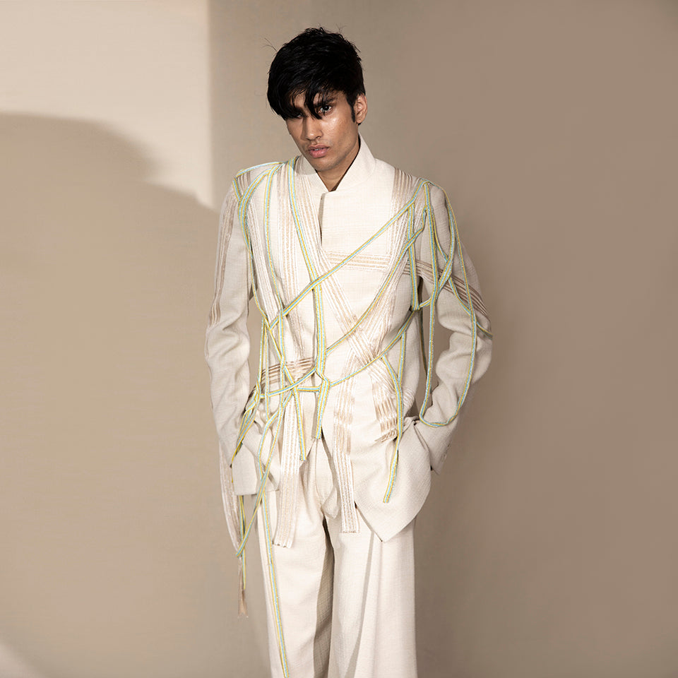 handloom bandgala jacket with criss-cross embellishment and mesh of neon beaded strings. the jacket is teamed up pleated wide pants. the look is perfect for someone who has style and believes in making a mark. the look is definitely a head turner.  #abhisheksharma #abhishekstudio #fashiondesignerabhisheksharma #bandgala #jacket #groom 