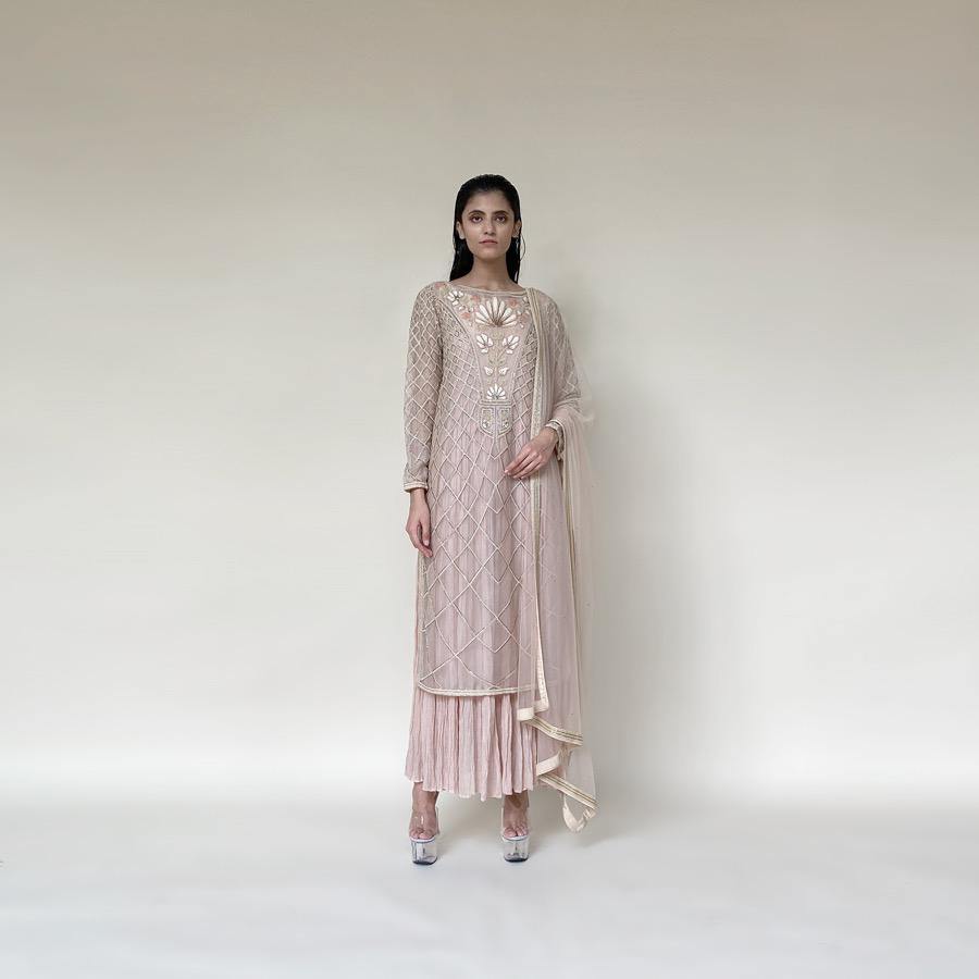 Organza silk kurta with fine Gresham and velvet applique embroidery embellished with pearl and katdana. There is a separate crinkled voile inner that gives the style a layered look. Elegance and delicate details are the main focus of the look. There is an interesting play of geometrical design with a hint of floral elements. Abhishekstudio, Abhishek Sharma