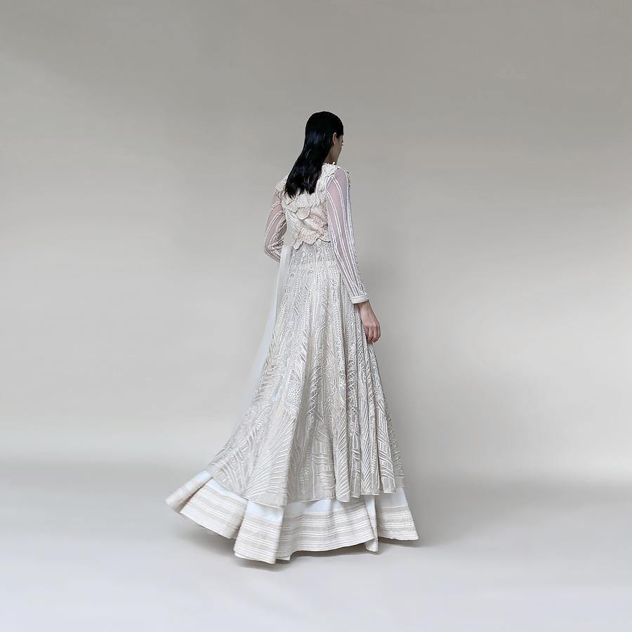 Organza embellished Anarkali with 3D draped embroidered bodice and dupatta. The Anarkali is designed taking inspiration from the beautiful palm trees and forest. There is a fine play of delicate net applique with fine Reshma and pearl detailing. The look has a very delicate and feminine vibe. Abhishek Sharma, abhishekstudio