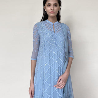 Chiffon Kalidas kurta with fine Resham shadow work and sequin embroidery. The kurta set has layered look and comes with a draped shaped stole, fitted pants and separate flared lining. The look is perfect for a refreshing and relaxed day. The look is perfect when you want to carry the grace and elegance with understated style. 