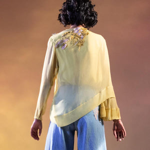 Chiffon front pleat draped top with placement embroidery. The top has a very elegant feel teamed up with high waisted flared jeans as shot on the model. The top can also be paired smart shorts, fitted pants depending on the mood And feel of the day. Abhishekstudio, Abhishek Sharma.