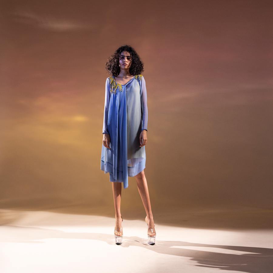 Chiffon draped asymmetrical tunic with front pleating. The tunic has a contrast lining to bring in the punch in the colour.   Styling: the tunic can be worn as a dress as shot on the model. It can also be teamed up with a pair of denim and fitted pants.  abhishekstudio, abhisheksharma.
