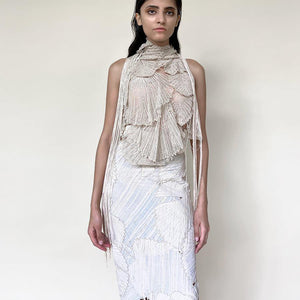 Huddled in-cut shoulder top with draped embroidery teamed up with high waisted patchwork skirt. The look is inspired by the whimsical nature of the forest and the play of varied textures of flora n fauna. The skirt is a patchwork of single detailed leafs that are put together to create this beautifully layered leaf feel in an asymmetrical way. 