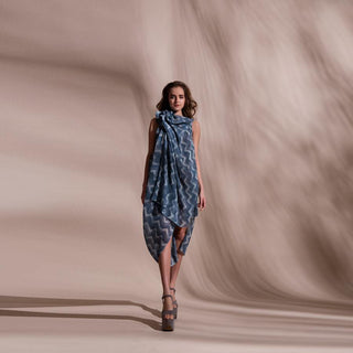 Chevron batik print pleat textured fluid draped georgette dress. It has draped ruffles around boat neck . It has a very fluid and elegant feel inspite of being an anti fit silhouette. The sleeveless draped cowl dress has very strong and dramatic vibe to it. abhishek sharma, abhishekstudio