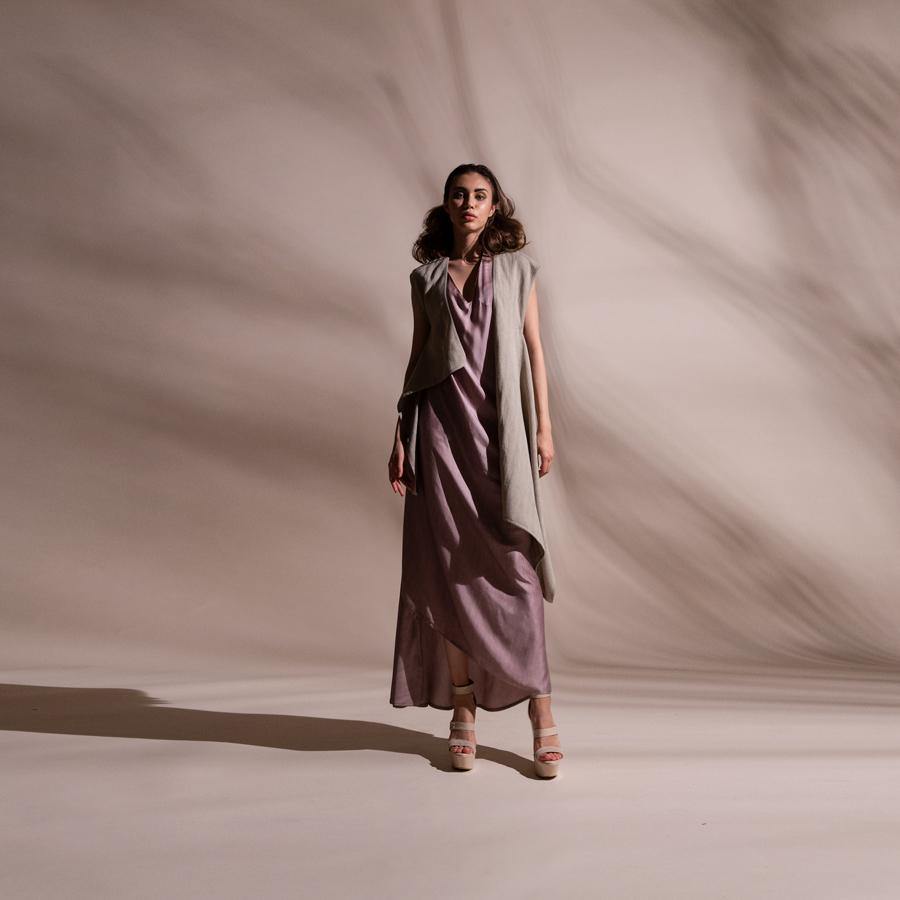 Asymmetric sleeveless draped jacket teamed up with satin draped dress. Crafted in fluid fabrics, Abhishek Sharma’s modern statement pieces pack in innovative drapery. abhishek sharma, abhishekstudio