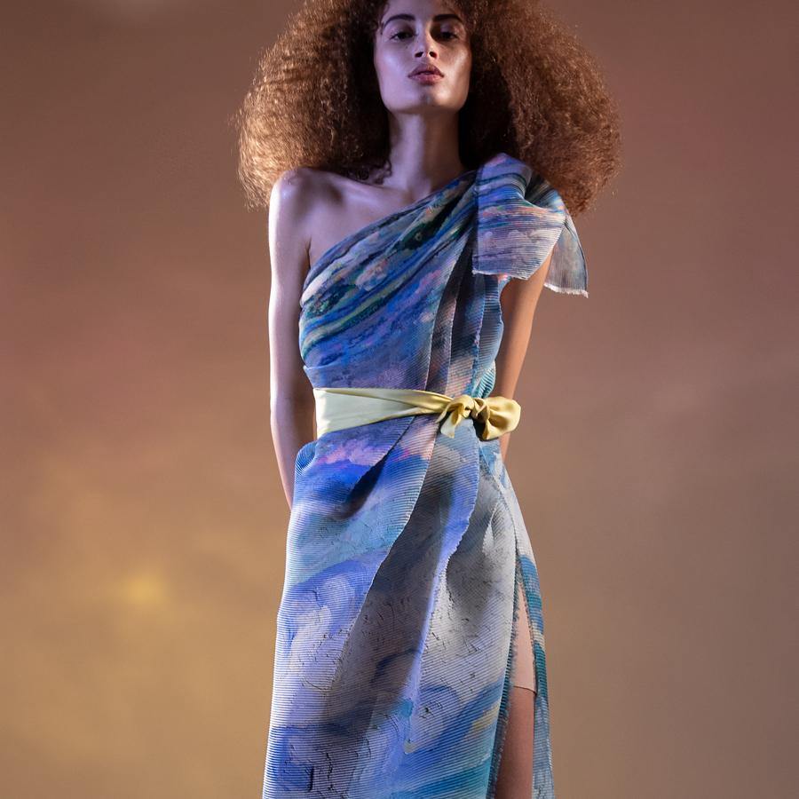 Abhishek Sharma’s fresh-off-the-runway collection features unconventional drapes with printed textures. Impressionist printed fine pleated one-off shoulder tie-up dress with high side slit. The dress has a young vibe. Ideal for a poolside party. You can style the dress with satin tie-up belt as shot on model or you can wear a sleek belt to accentuate the waist. Abhishekstudio, Abhishek Sharma 