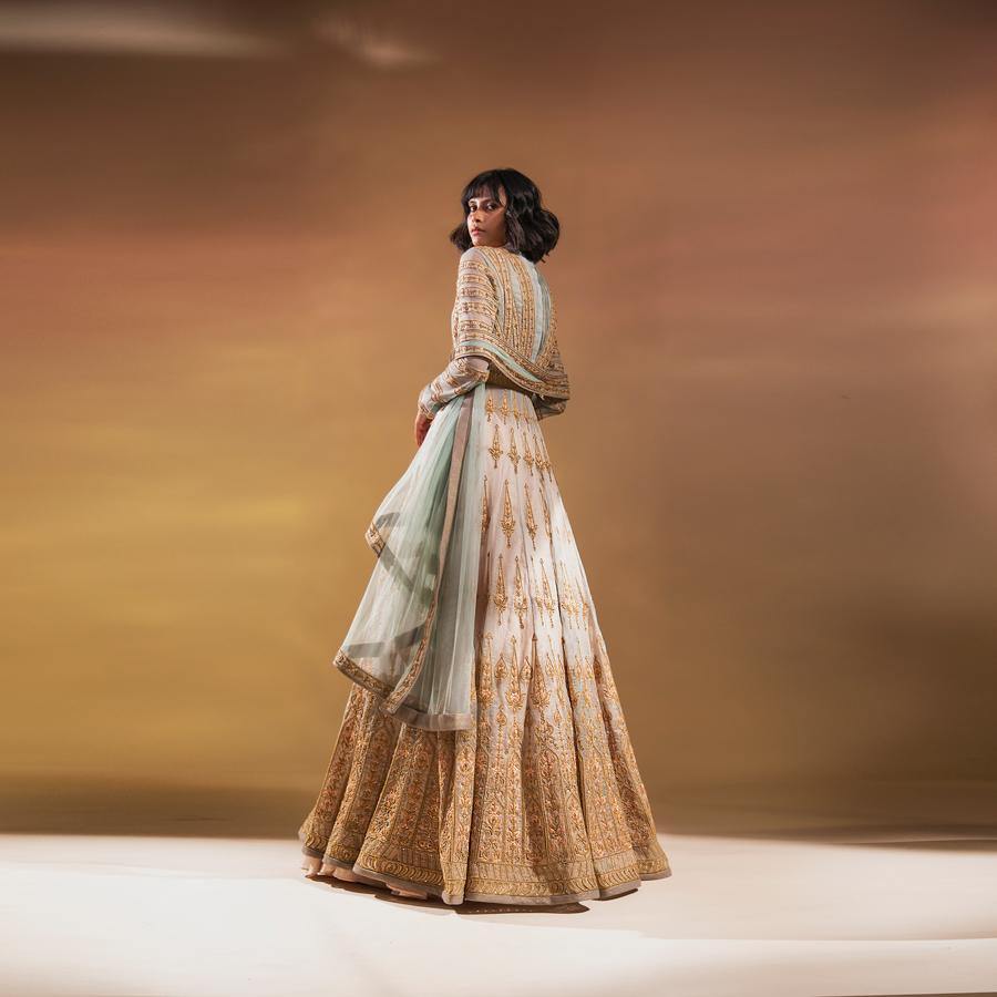 Silk organza embellished multi panelled flared jacket with fluted bodice and shaped duptta teamed up flared plain skirt. The look has a traditional regal feel and is perfect for Wedding functions.  Styling : The is perfect for some who has taste for intricate embroidery and appreciates a twist to traditional classic look. Style it vintage polki jewellery. Abhishekstudio, Abhishek Sharma 
