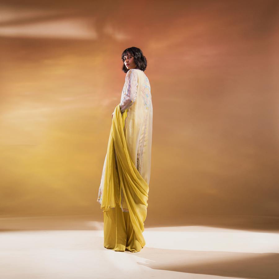 Silk organza embellished straight kurta with contrast lining teamed up with wide pants and chiffon duptta. It a stylised version of the classic straight kurta. There is fine play of multi colour resham and beads. A perfect look for a simple gathering where you want to stand out without much of an effort. An elegant and chic style. Abhishekstudio, Abhishek Sharma