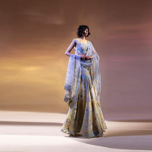Impressionist art inspired embellished lengha with play of asymmetrical shapes and varied textures. The blouse has 3D draped embroidery and see through back. There is delicate play of lines on the net duptta with adds sensual, feminine touch to the look. The style is a perfect for someone who is looking newness in the traditional attire. The look can perfectly work for a roka, ring ceremony or even mehndi where you want to have fun vibe with touch of tradition. Abhishekstudio, Abhishek Sharma 